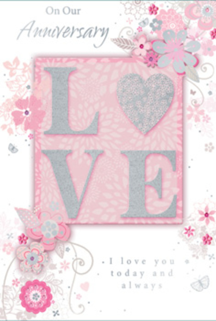 The photograph shows a beautifully crafted anniversary card that feels as tender and thoughtful as a hand-delivered bouquet arriving at a doorway in Collier Row. At its heart, the large word LOVE stands prominently in raised, glitter-kissed lettering, the fine sparkle suggesting how the surface would catch the light with each gentle movement. This central word rests on a blush-pink rectangular panel, softly contoured and slightly shaded to create a layered effect, as though it is mounted above the base of the card. Surrounding this centrepiece is a flowing arrangement of stylised blooms and curling foliage, painted in a palette of blush pinks, pearlescent whites, gentle greys, and hints of silver. The flowers are delicately defined, each petal outlined with precision, like the first lines of a florist's sketch for an anniversary display. They radiate outwards but never seem crowded, giving the card a refined sense of space beloved by those who appreciate a well-balanced arrangement. Interlaced between the blossoms, slender vines and tiny leaves curl and twist, adding a sense of soft movement and guiding the eye around the design. The background remains a serene, powdery pink, offering a warm, romantic canvas that complements the central motif. Just beneath or beside the floral work, an anniversary message is printed in elegant script, flowing like a handwritten note tucked into a bouquet from Flowers Collier Row. The overall tone is one of quiet celebration and lasting devotion, evoking evenings spent together, shared memories rooted in the local area, and the gentle joy of marking another year side by side.